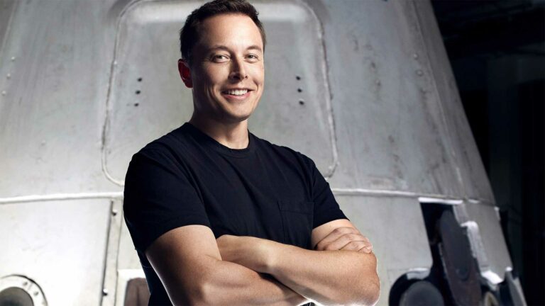 Elon Musk (man) smiling at camera