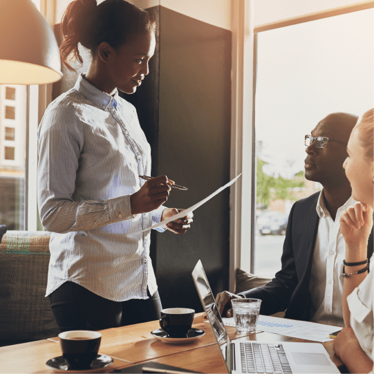 Woman standing in board meeting