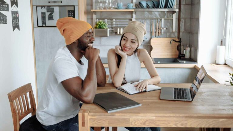 Man and woman looking for a business name on a laptop