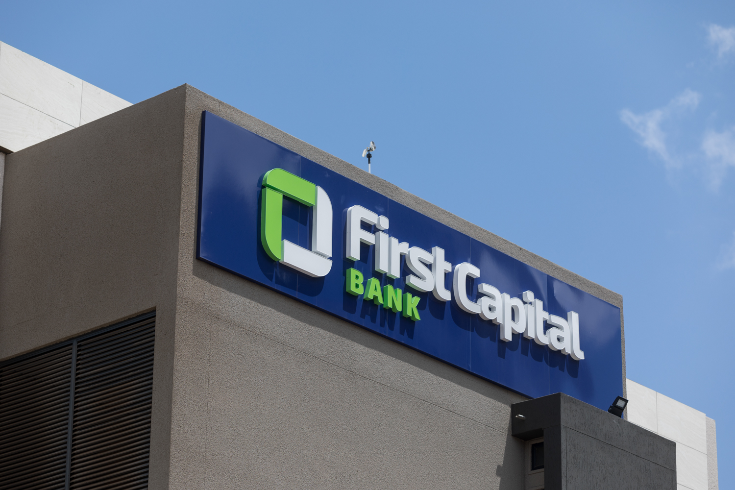 First Capital Bank Branch Exterior Signage | Brimco First capital bank building signage with blue and green logo on a sunny day