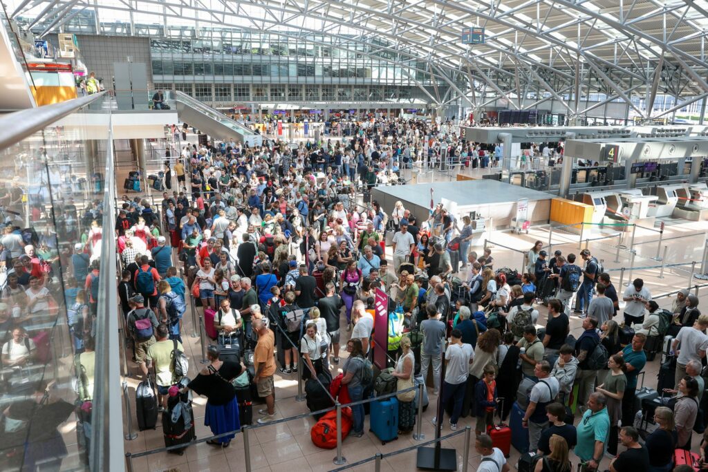 Crowded airport terminal with passengers affected by a global tech outage