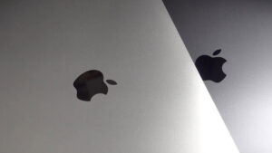 Close up of apple logos on silver and space gray apple devices highlighting the brands iconic design