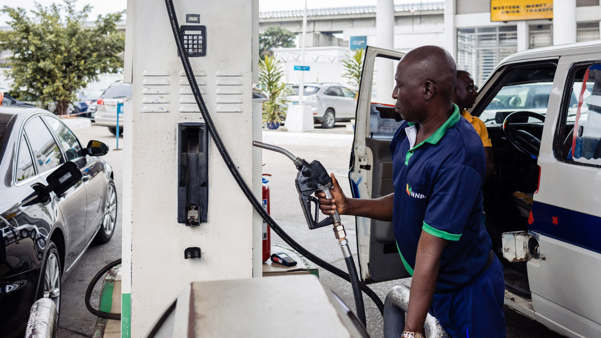 An attendant handles a fuel pump at a gas station in lagos nigeria  photographer benson beabuchibloomberg