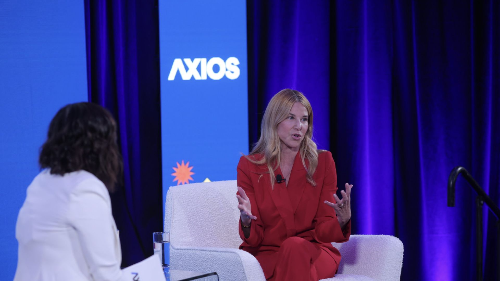 Denise Dresser Discusses the Future of Slack at Axios Forum | Brimco Denise dresser ceo of slack speaks on stage at the axios forum wearing a red suit discussing workplace communication innovations