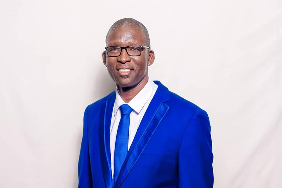 Dr Micus Chiwasanee Chimbombi - A Portrait of Leadership | Brimco Dr Micus chiwasanee chimbombi wearing a blue suit and tie smiling against a light background