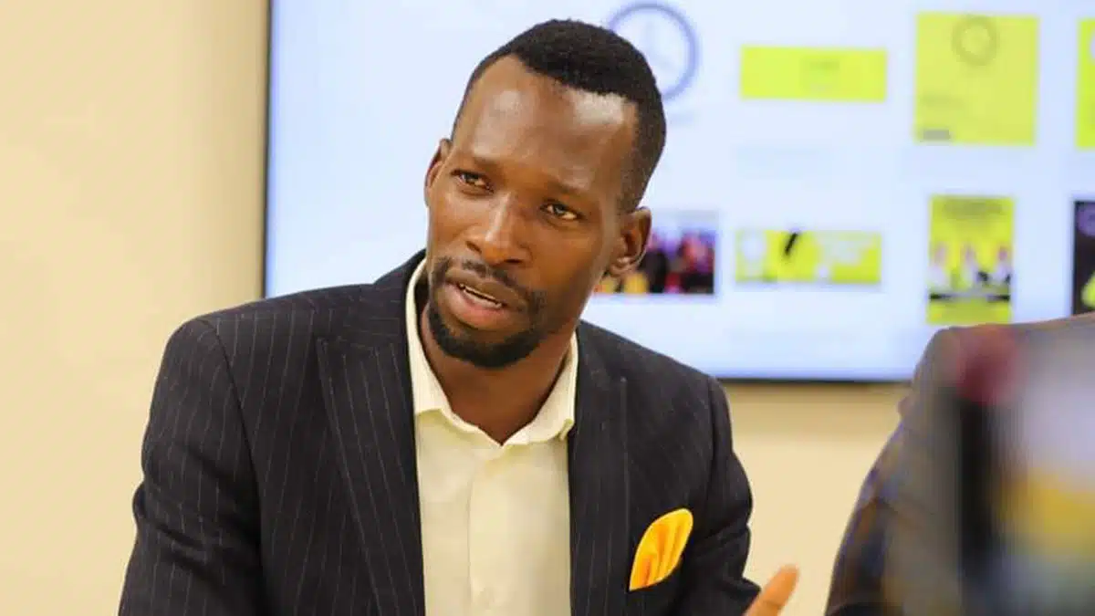 Lawrence Ookeditse Speaks at BPF Meeting | Brimco Lawrence ookeditse speaking during a botswana patriotic front meeting dressed in a dark suit with a yellow pocket square