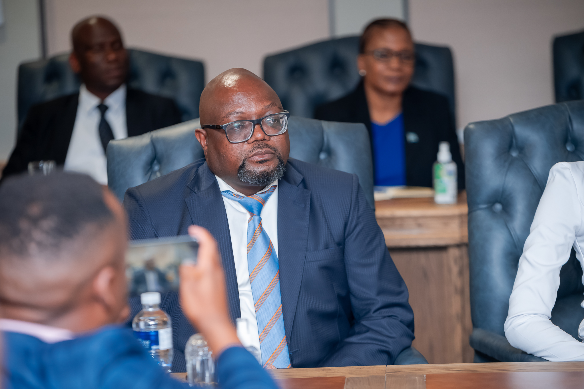 Dr. Phenyo Butale - Botswana's Minister of International Relations | Brimco Portrait of dr Phenyo butale botswanas minister of international relations wearing a blue shirt and glasses