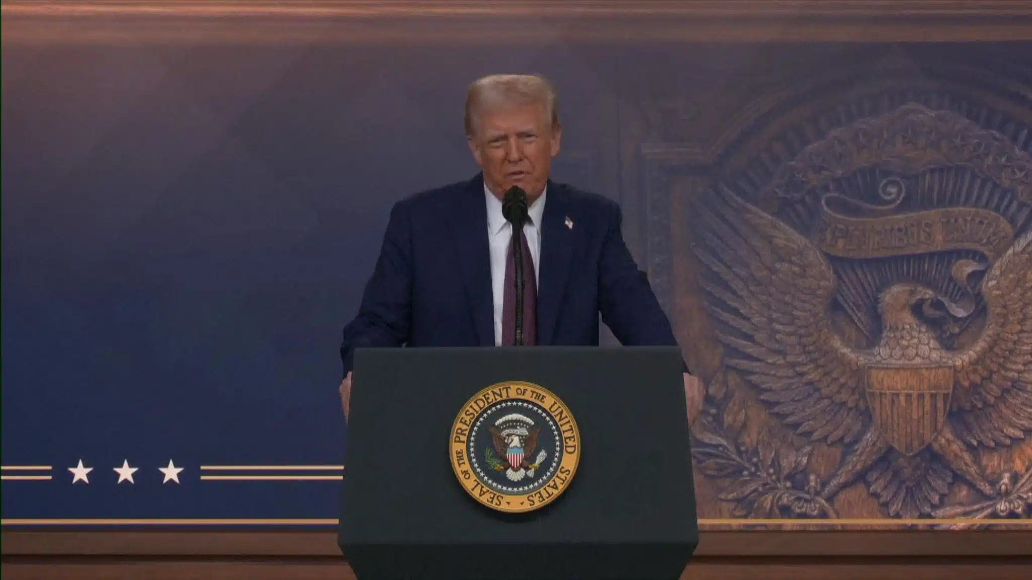 President Trump Addresses the Nation on Strategic Policies | Brimco President donald trump delivers a speech at the presidential podium standing in front of a backdrop featuring the u S Presidential seal and an e pluribus unum emblem