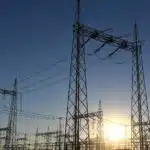 High voltage botswana power corporation power lines and transmission towers at sunrise
