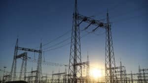 High voltage botswana power corporation power lines and transmission towers at sunrise