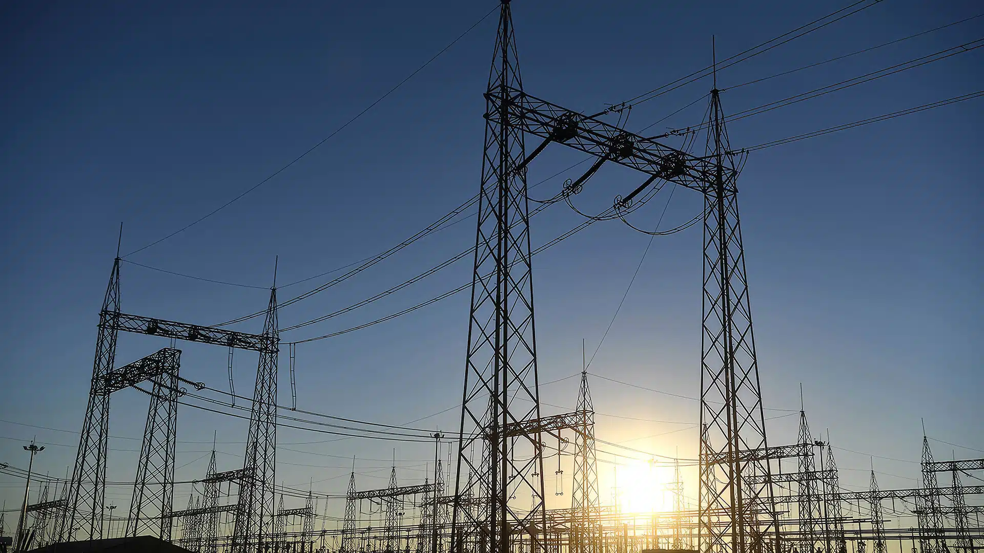 Botswana Power Corporation - Energizing the Nation at Dawn | Brimco High voltage botswana power corporation power lines and transmission towers at sunrise