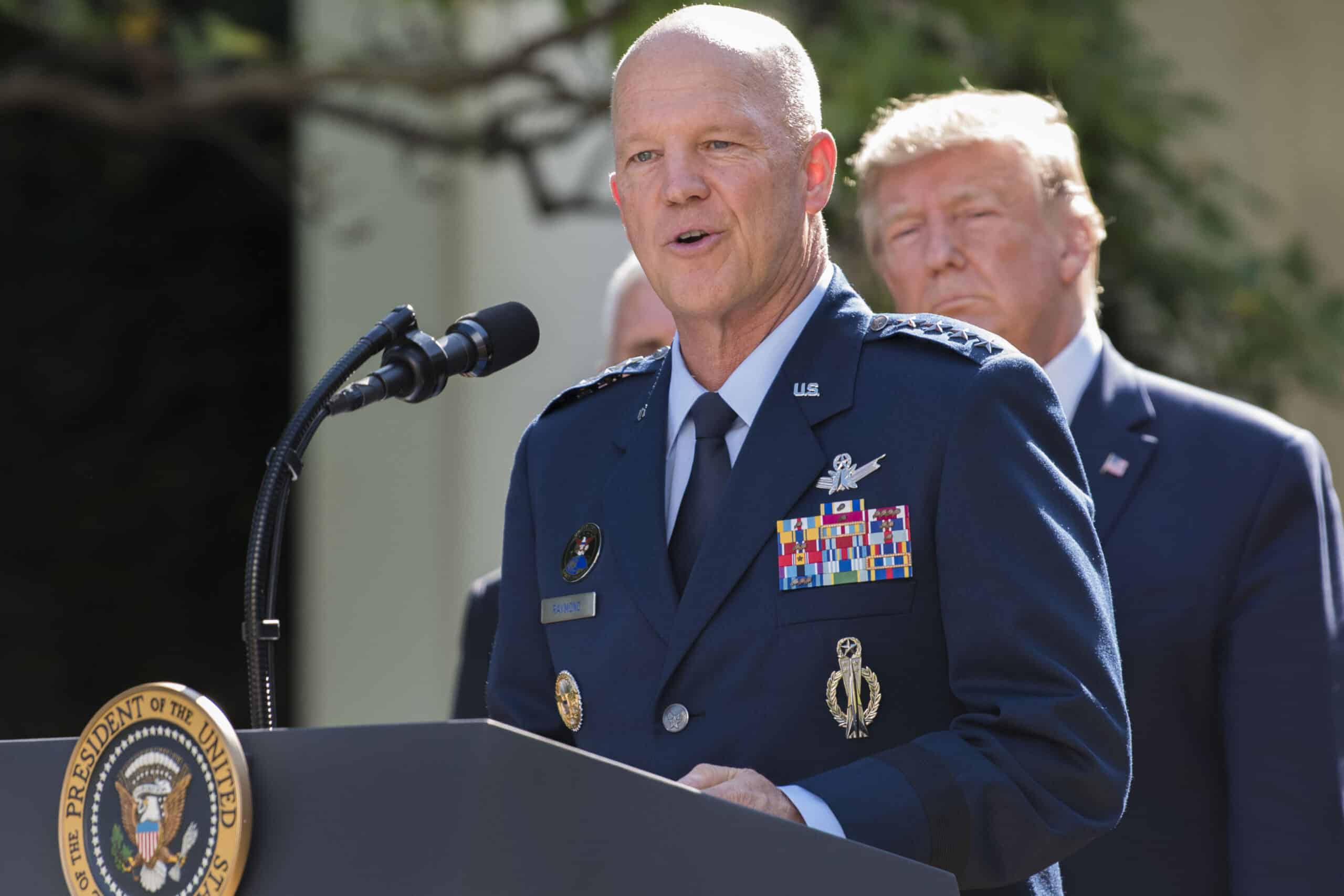 President Trump Hosts Event to Establish US Space Command | Brimco General john w Raymond speaks at a podium during the u S Space command inauguration ceremony with president donald trump standing behind him