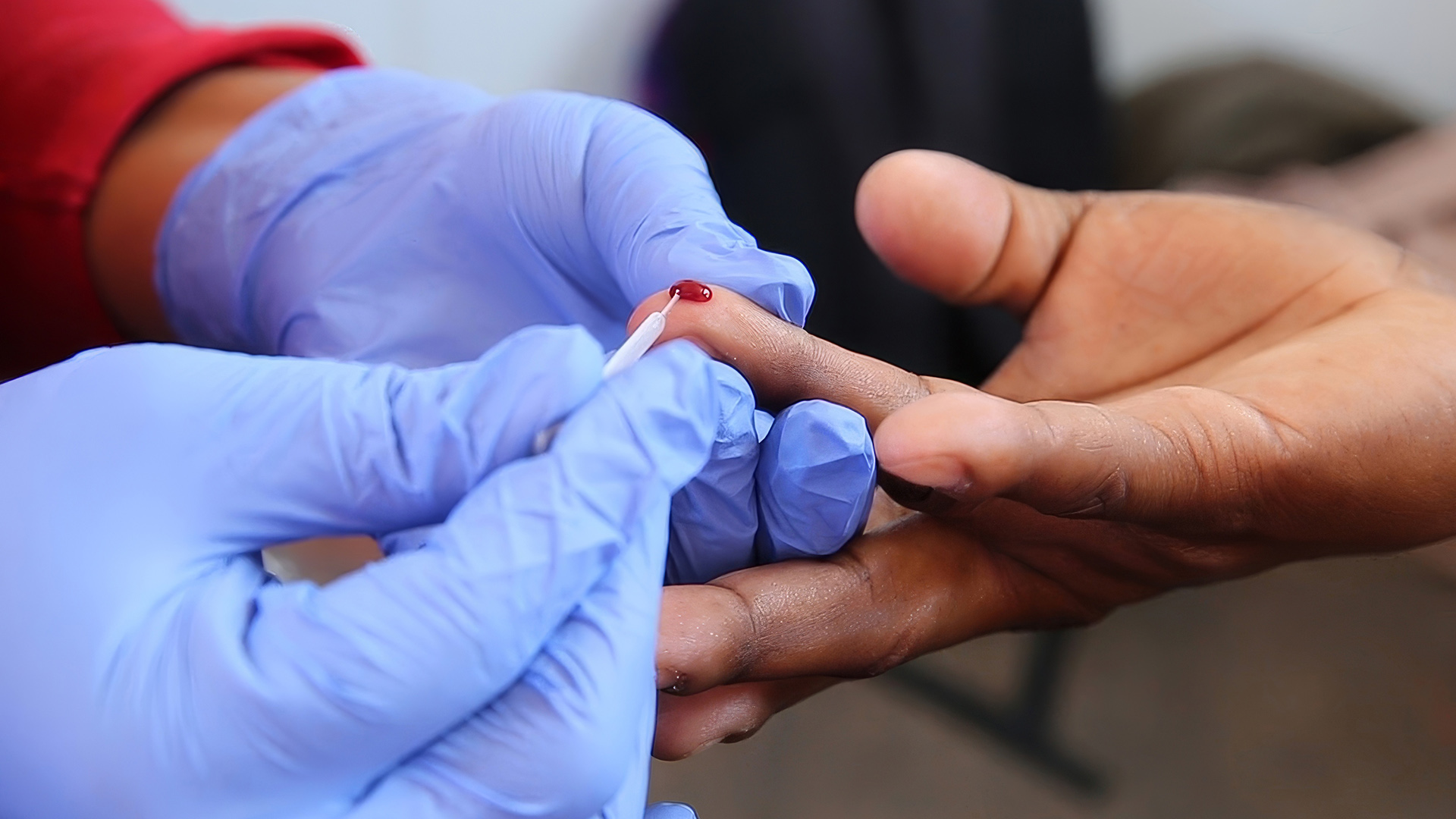 HIV Testing Marks a New Era in Africas Fight Against the Virus | Brimco Close up of a gloved healthcare worker collecting a blood sample from a fingertip for an hiv test