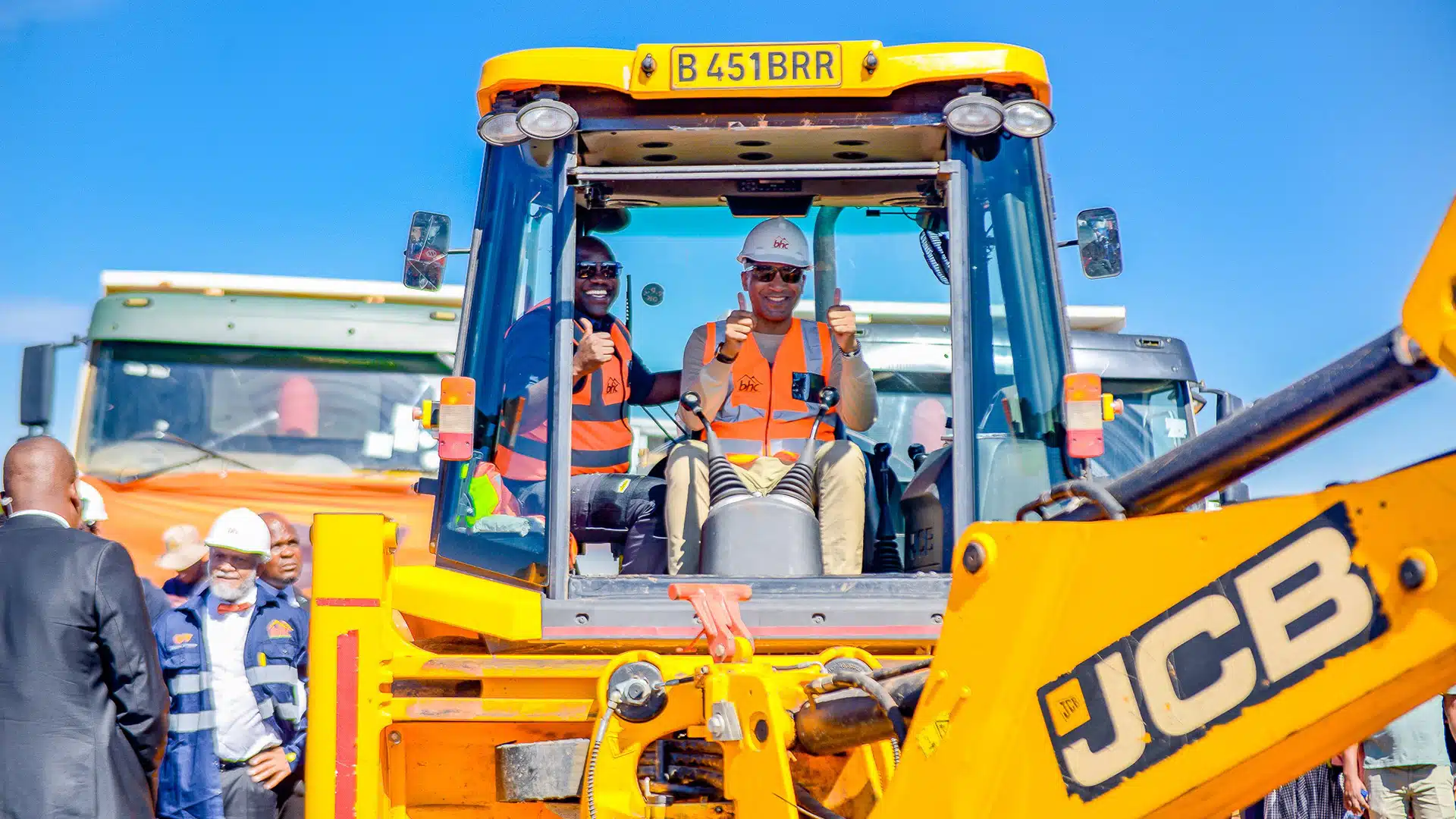 President Duma Boko Breaks Ground at Bonno Programme Launch | Brimco President duma boko inside a yellow jcb excavator giving thumbs up during the bonno programme launch surrounded by officials and attendees