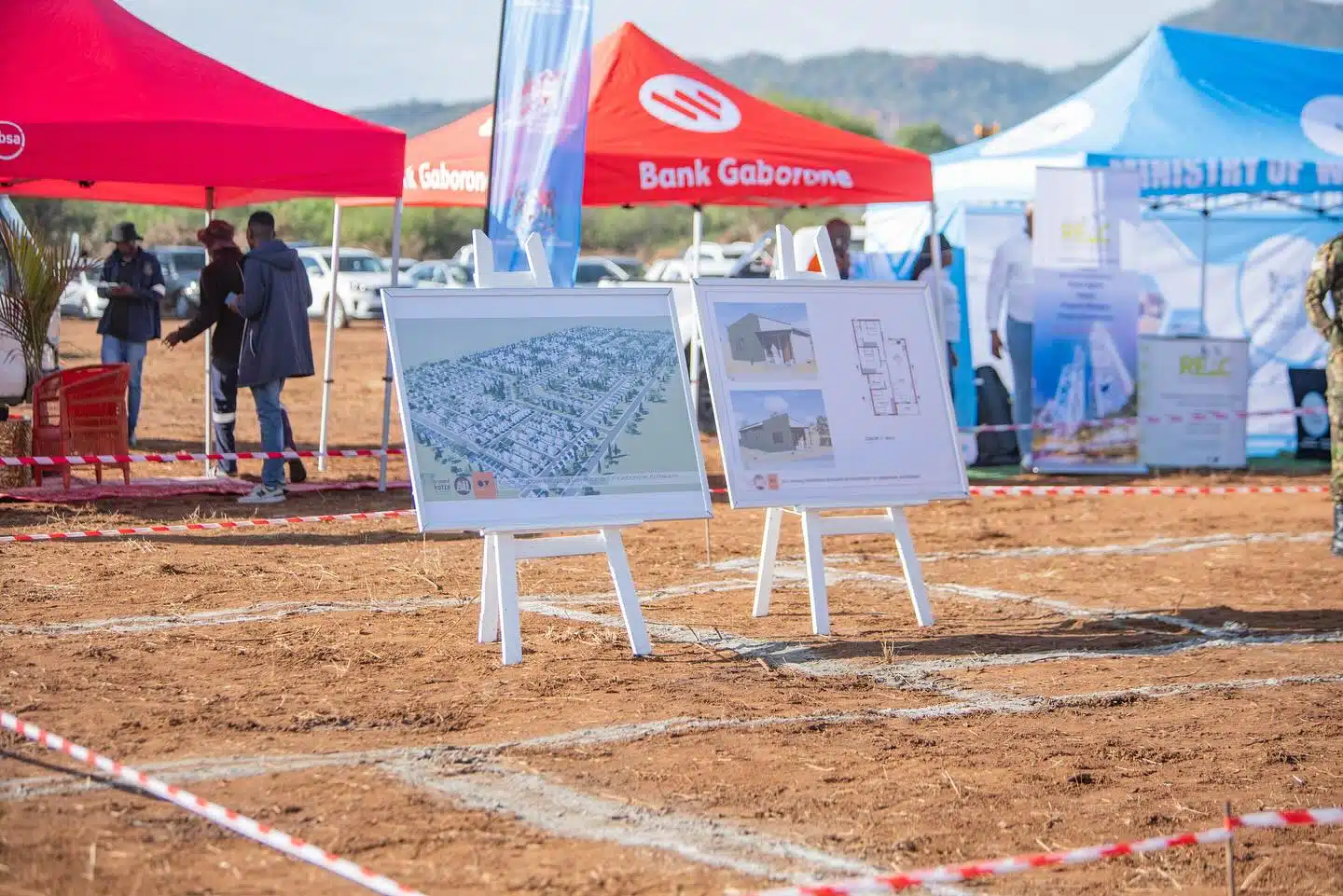 Site Plans Unveiled at Bonno Programme Groundbreaking Ceremony | Brimco Site plans displayed on easels at the bonno programme launch event in botswana with tents and attendees in the background