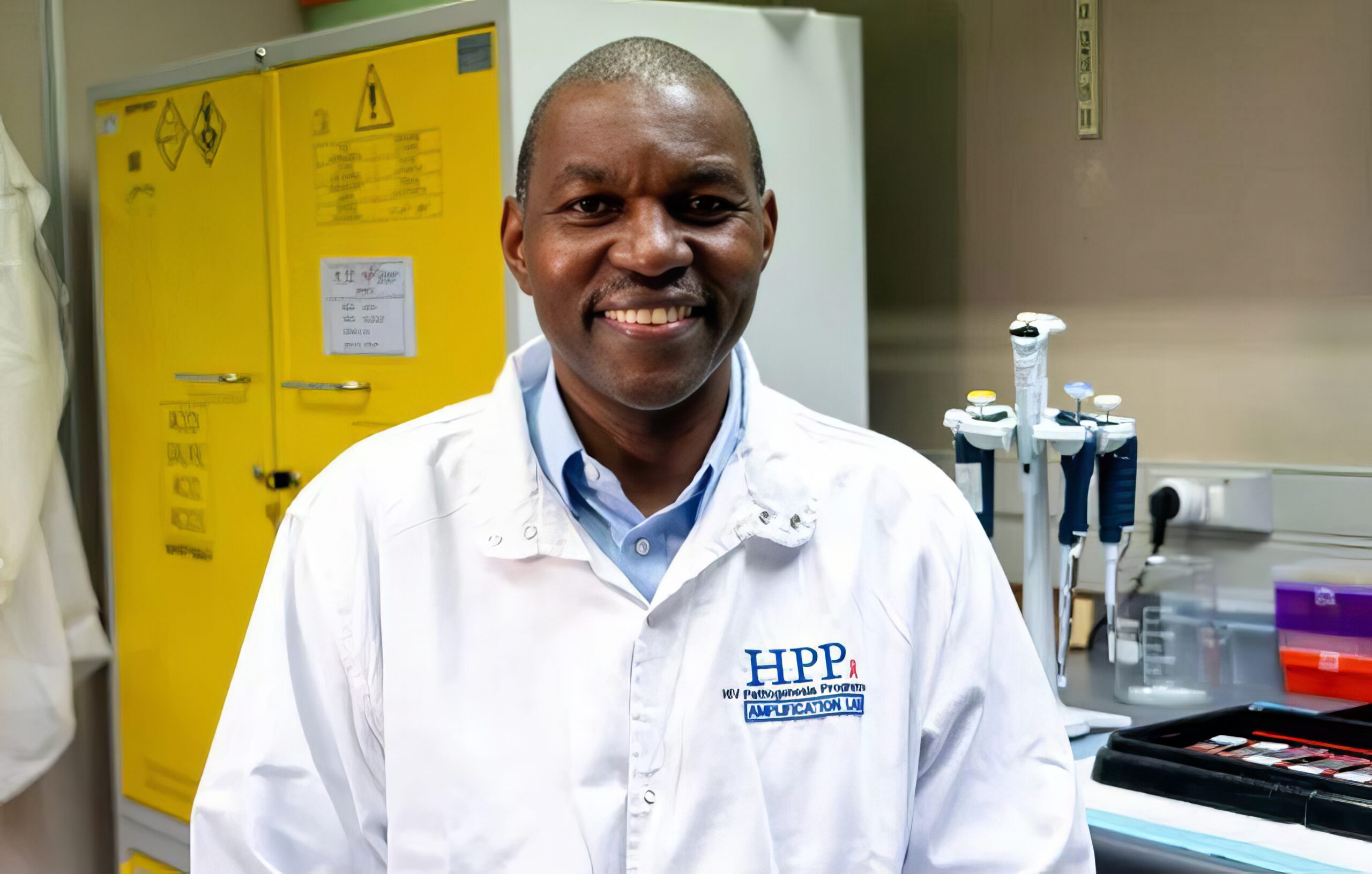 UKZNs Professor Thumbi Ndungu | Brimco Professor thumbi ndungu in a lab coat smiling in the hiv pathogenesis programme lab at ukzn