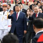 Chinese president xi jinping and vietnams communist party general secretary to lam wave as they walk during a formal welcome procession in hanoi