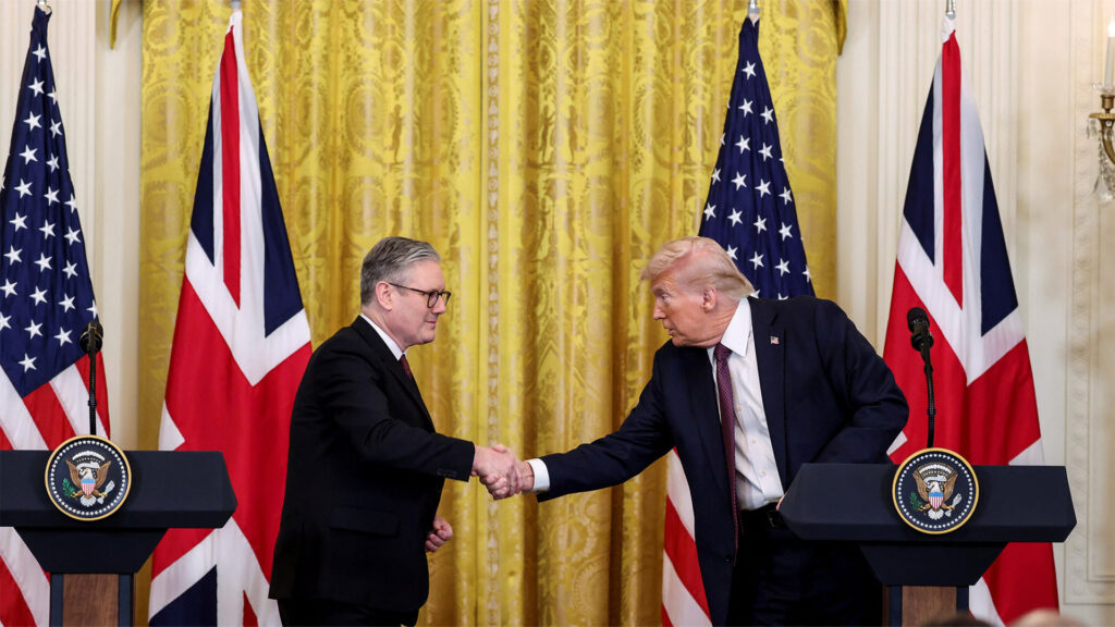 President donald j Trump and uk labour leader keir starmer shaking hands during a joint press conference with american and british flags in the background