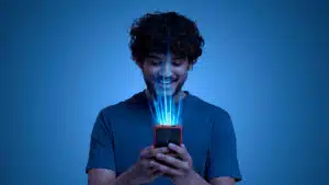 Smiling young man using a smartphone with digital beams symbolizing seamless esim mobile connectivity