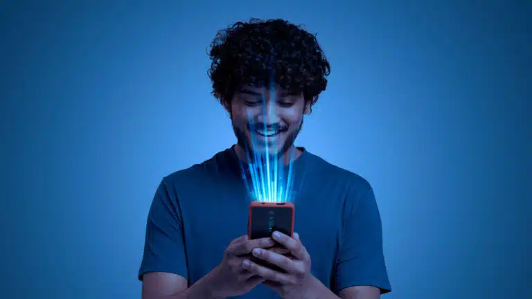 Smiling young man using a smartphone with digital beams, symbolizing seamless eSIM mobile connectivity
