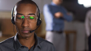 Customer service representative wearing a headset focused and attentive in a support environment