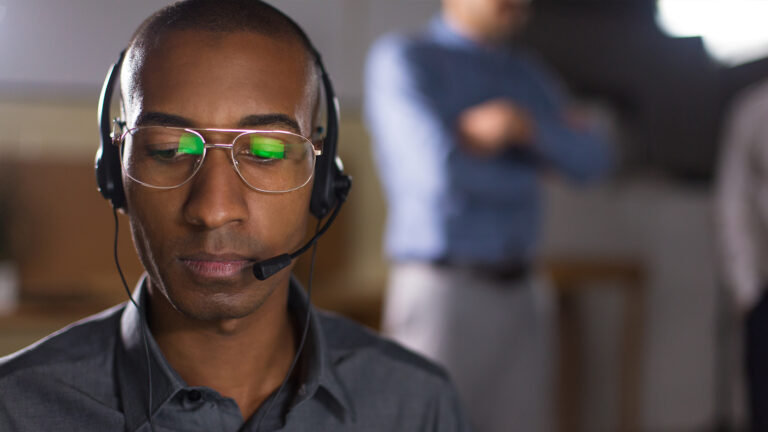 Customer service representative wearing a headset focused and attentive in a support environment