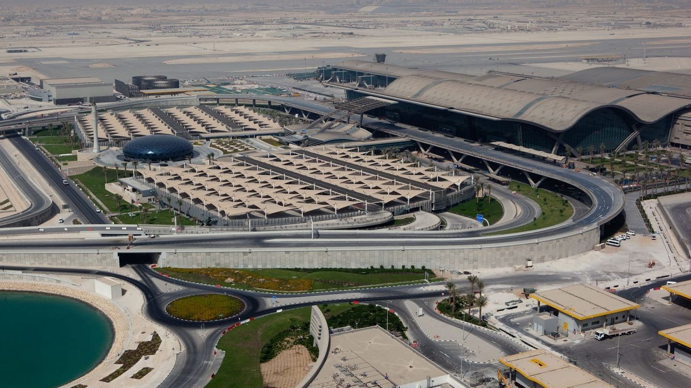 Hamad International Airport in Qatar | Brimco Aerial view of hamad international airport featuring modern terminal buildings road infrastructure and landscaped areas
