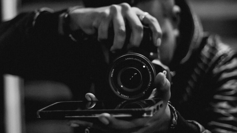 Photographer taking a photo with a dslr camera representing creative professionals building online portfolios