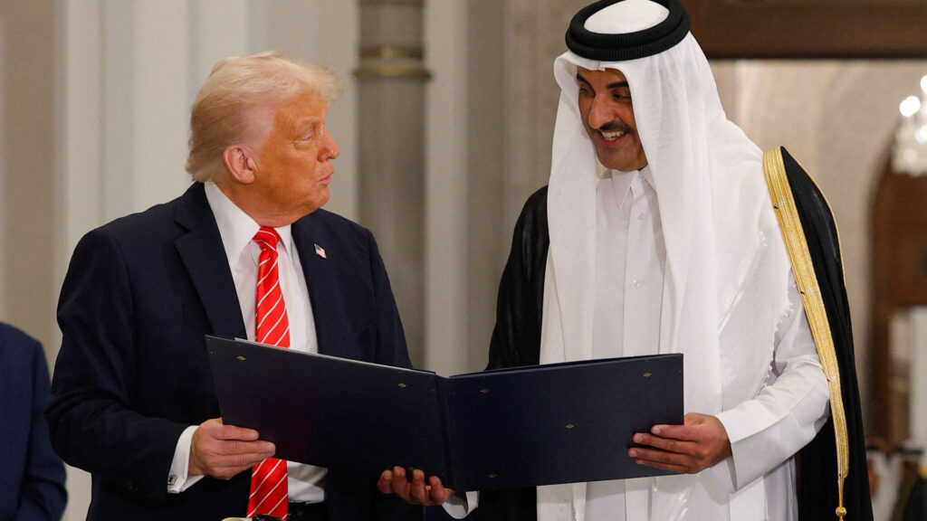 Donald trump and emir sheikh tamim bin hamad al thani holding a formal document together symbolizing a diplomatic agreement between the united states and qatar