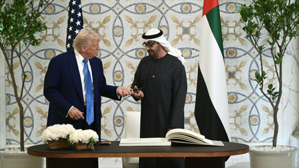 Donald trump and sheikh mohamed bin zayed al nahyan at a signing ceremony exchanging a pen as they formalize a strategic agreement between the united states and the united arab emirates