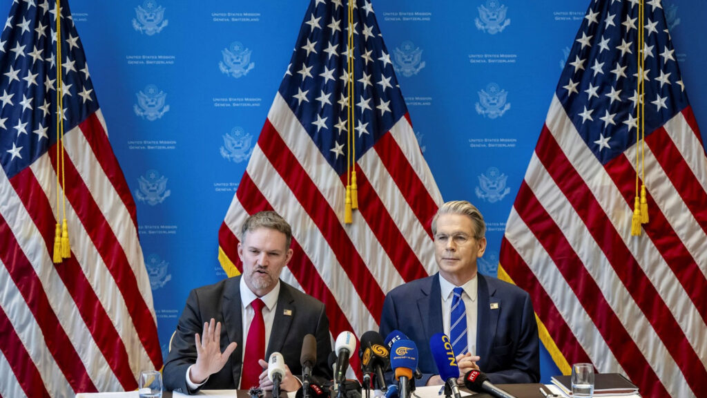 U S Trade representative jamieson greer and secretary of the treasury scott bessent speaking at a press conference in geneva with u S Flags and microphones in the foreground
