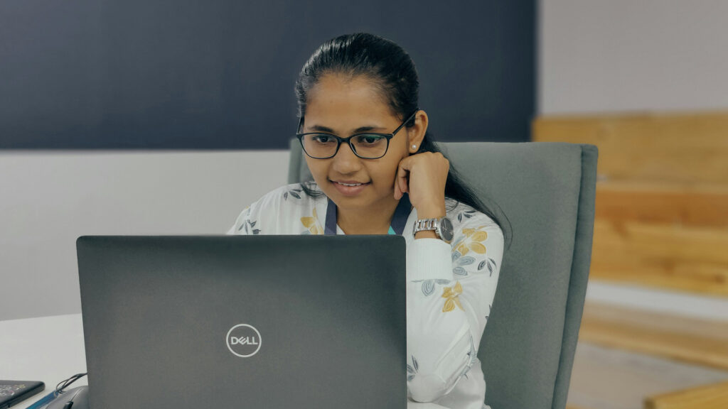 Focused woman using a laptop analyzing datarepresenting evolving consumer credit behavior