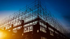 Steel scaffolding and framework silhouetted against the sunset sky showing modern construction in multi residential building development