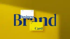 Two business cardsone white one yellowplaced over the word brand on a vibrant yellow background illustrating brand identity and design