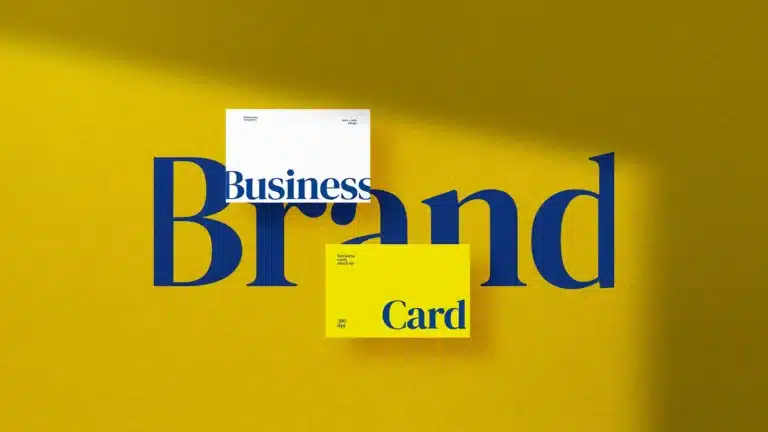 Two business cardsone white one yellowplaced over the word brand on a vibrant yellow background illustrating brand identity and design