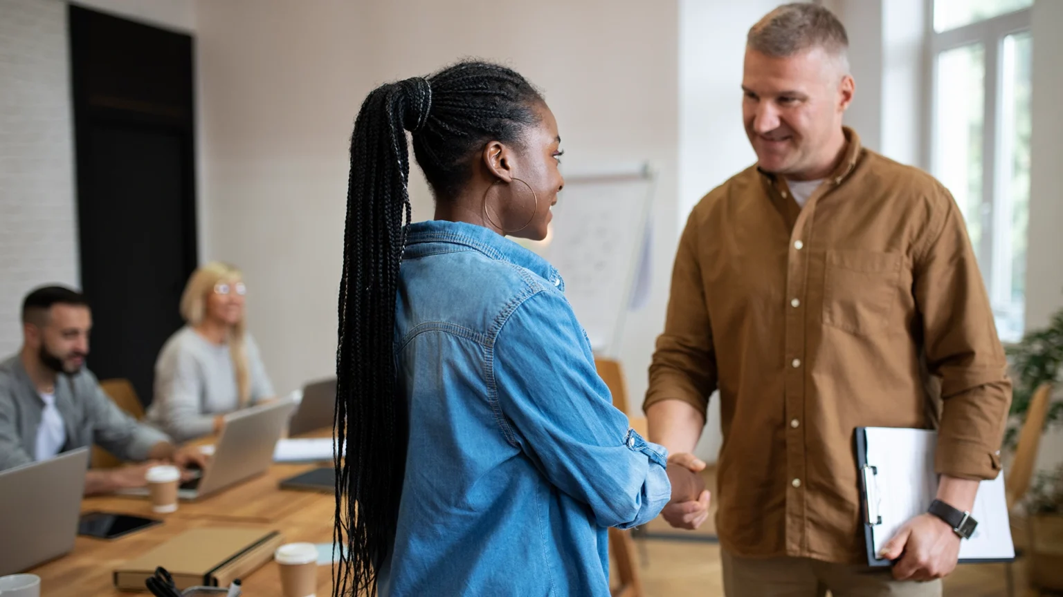 Two professionals shaking hands during a business meeting