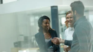 Business professionals shaking hands in an office environment