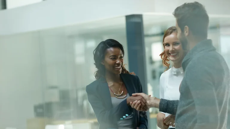 Business professionals shaking hands in an office environment
