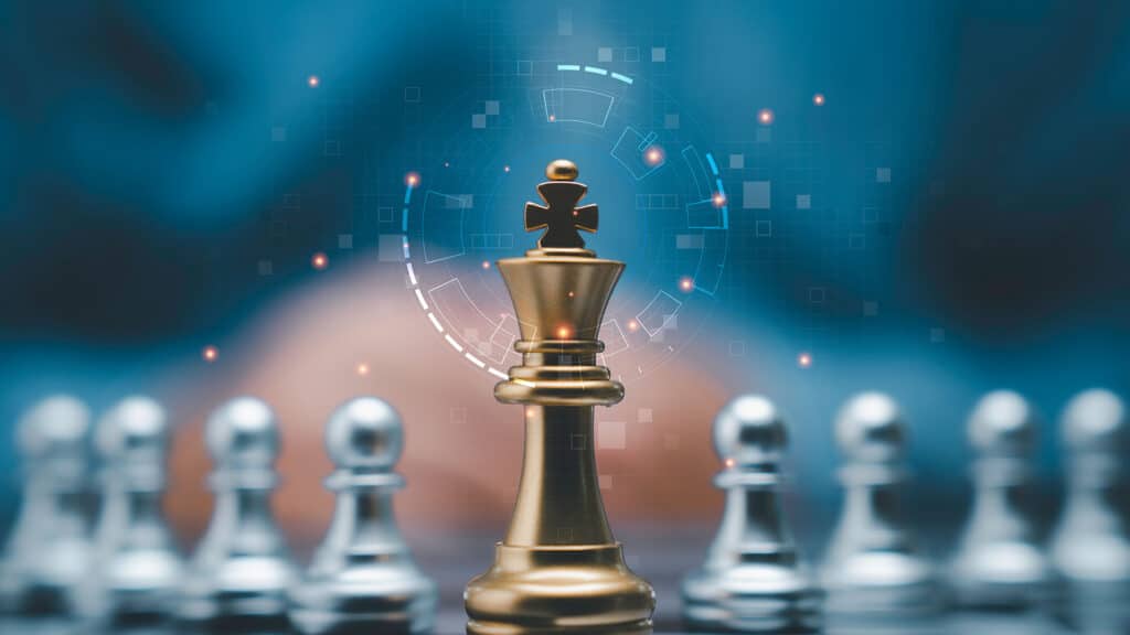 Golden king chess piece standing against silver opponents, symbolizing leadership.