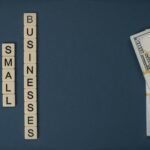 Support small businesses text with stack of dollar bills