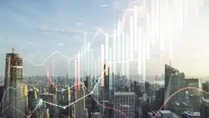 City skyline with transparent financial graphs and market data overlays representing global economic trends