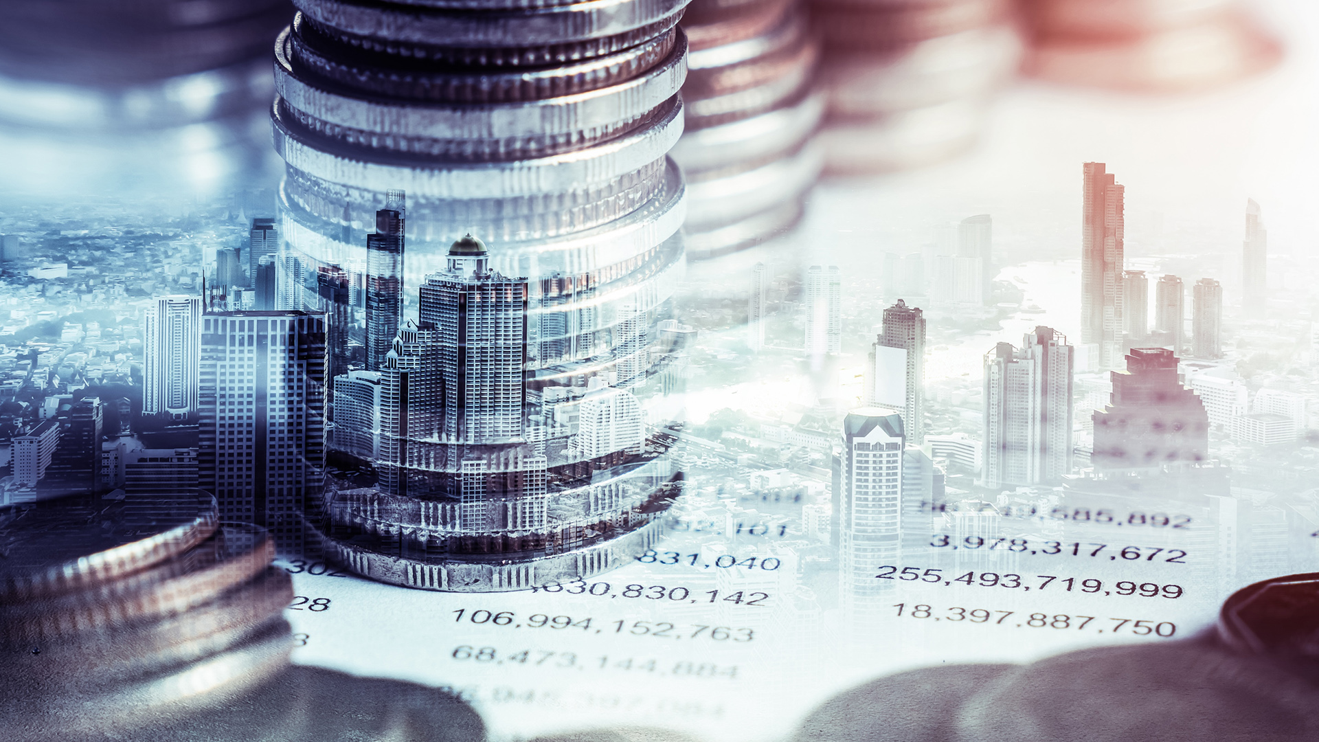 The Intersection of Finance and Growth | Brimco Overlay image of tall stacks of coins and a city skyline symbolizing financial growth investment and economic development