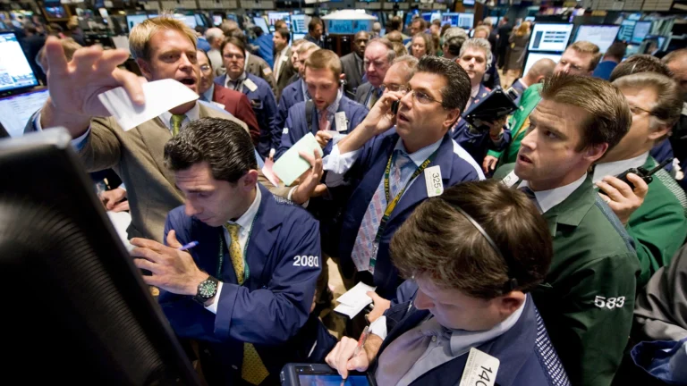 Traders on the floor of the New York Stock Exchange react to market volatility during the 2008 financial crisis.