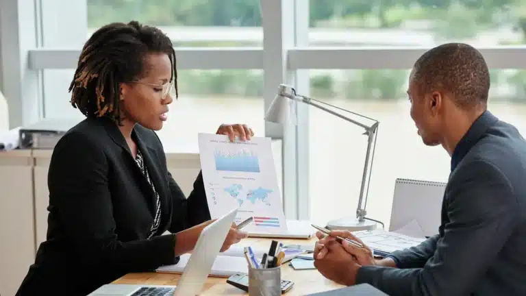 Businesswoman presenting analytics charts to a colleague during a meeting