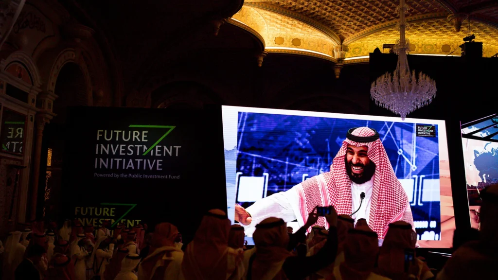 Global Leaders Gather at Saudi Arabias Future Investment Initiative | Brimco Delegates gathered in riyadh at the future investment initiative with a large screen displaying a keynote speaker in traditional attire