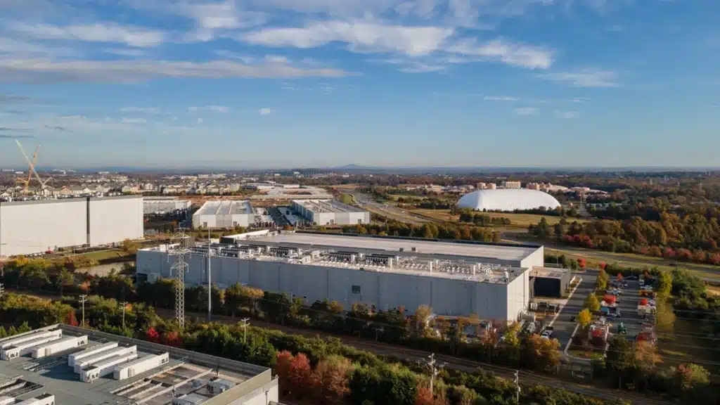 An aerial photo of the meta platforms inc Data center campus in ashburn virginia showing large industrial buildings surrounded by trees and supporting infrastructure