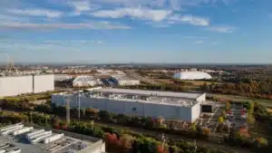 An aerial photo of the meta platforms inc Data center campus in ashburn virginia showing large industrial buildings surrounded by trees and supporting infrastructure