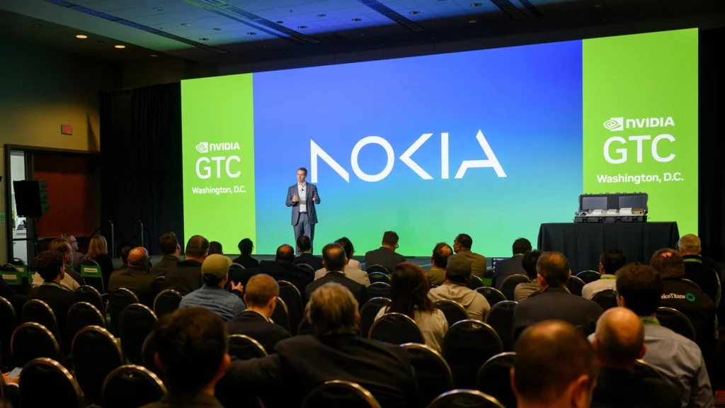 Nokia Presents at NVIDIA GTC in Washington DC | Brimco Speaker presenting on stage at nvidia gtc in washington d C With a large nokia logo on screen and audience seated in front