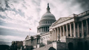 The united states capitol building with the american flag flying representing u S Government and democracy