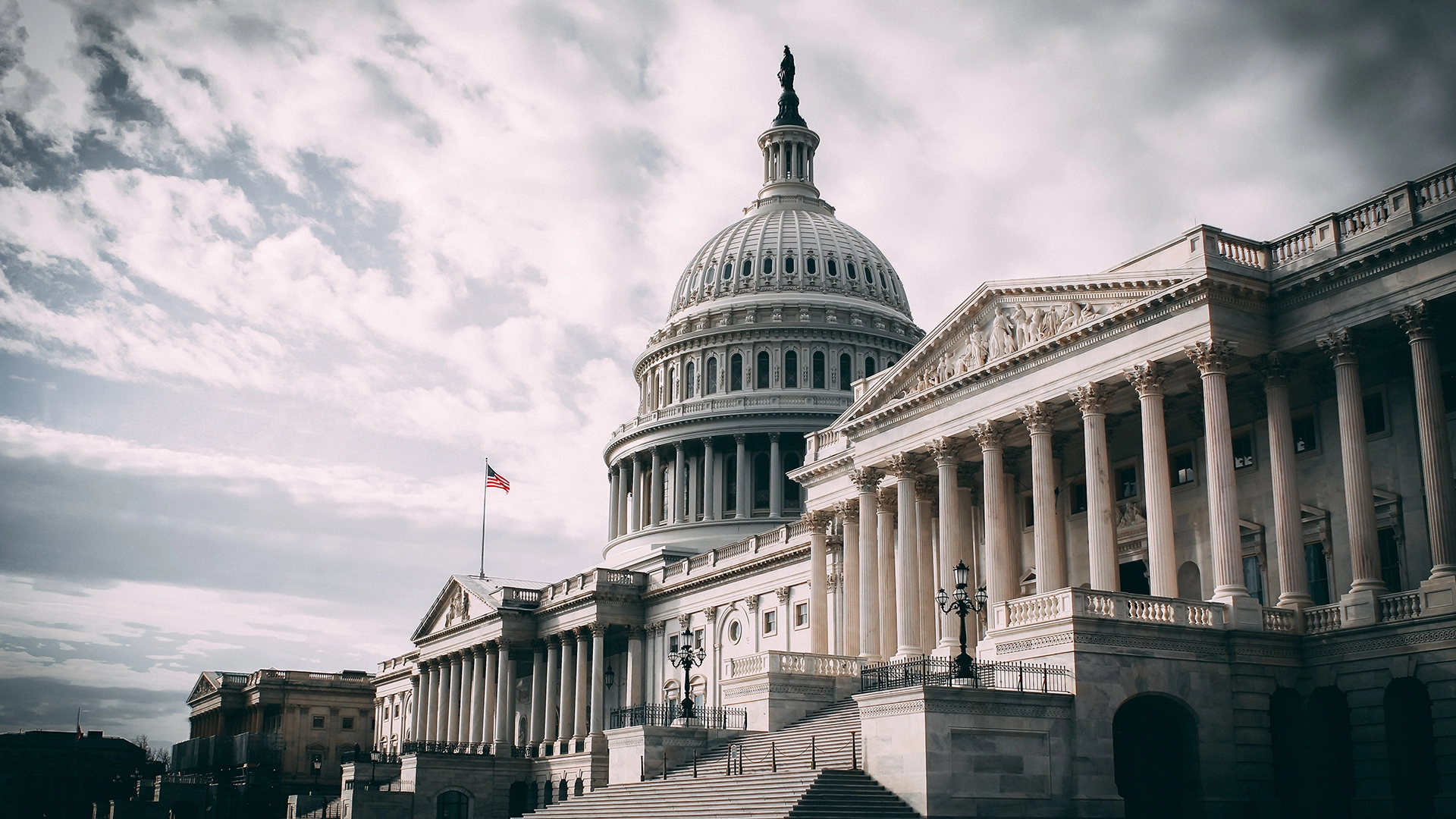 The United States Capitol Symbol of Democracy and Governance | Brimco The united states capitol building with the american flag flying representing u S Government and democracy